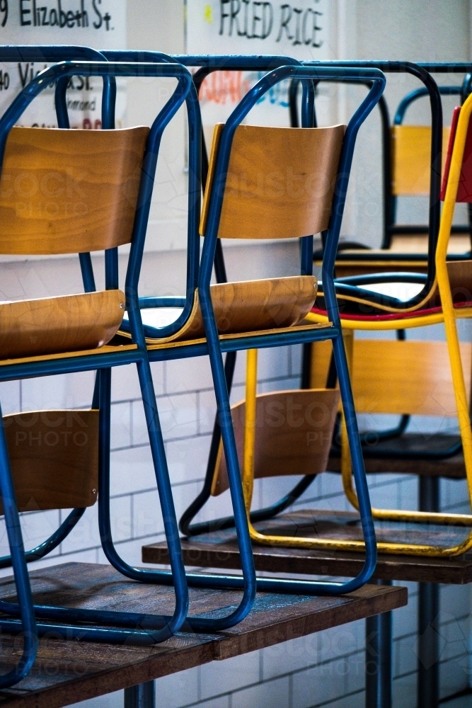 Stacked chairs in a laneway cafe - Australian Stock Image