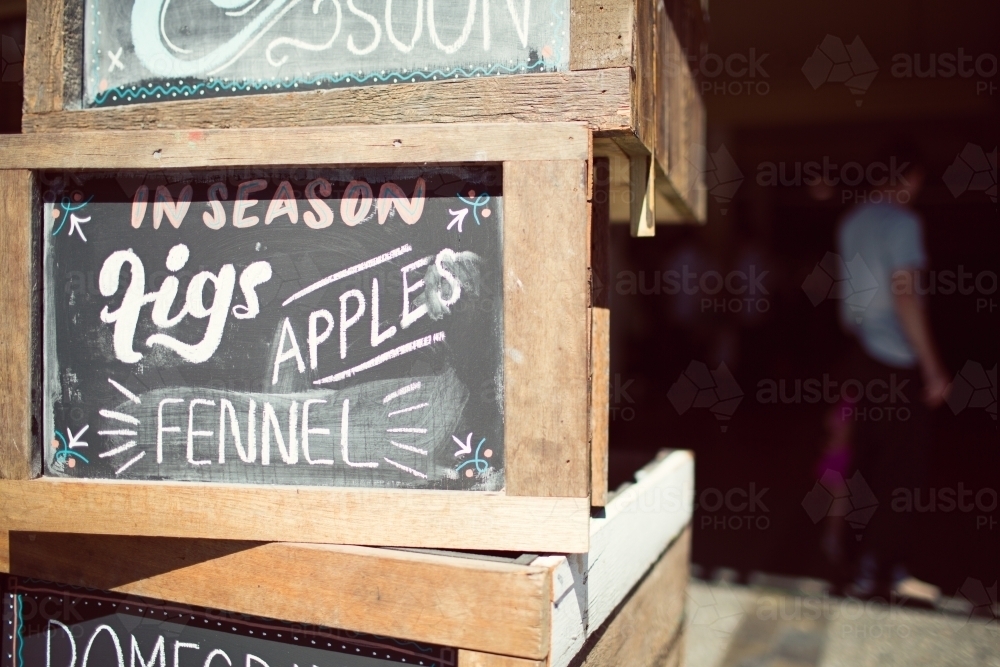 Stacked wooden crates with chalkboard signs - Australian Stock Image