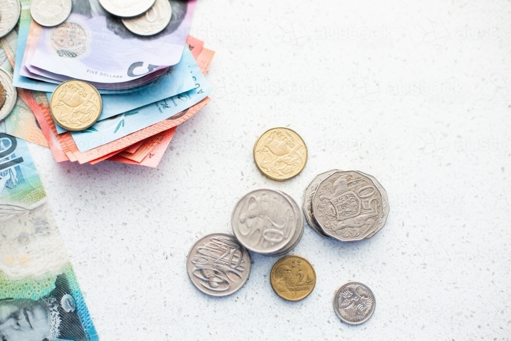stacks of Australian coins with more money on the edge of frame - Australian Stock Image