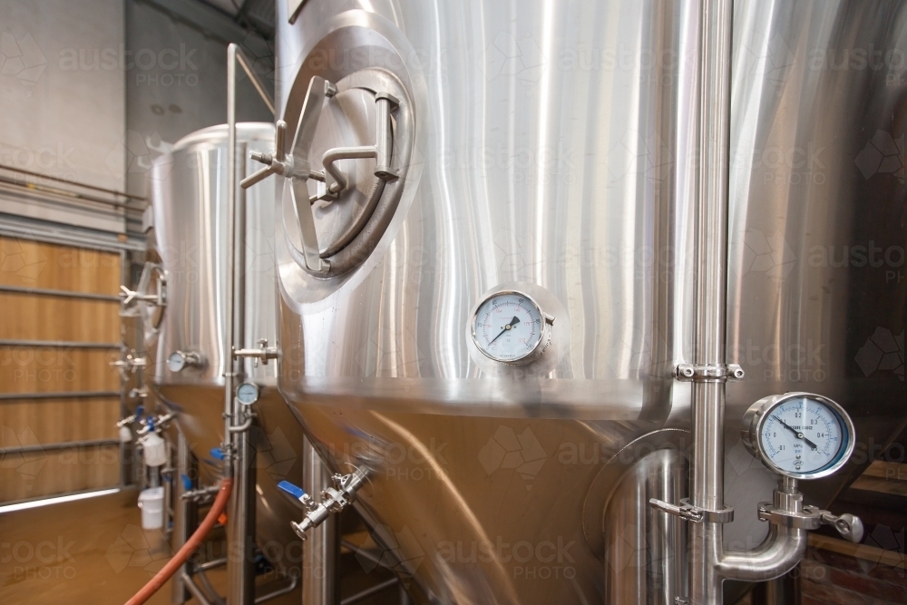 Stainless steel tanks and gauges at a microbrewery - Australian Stock Image