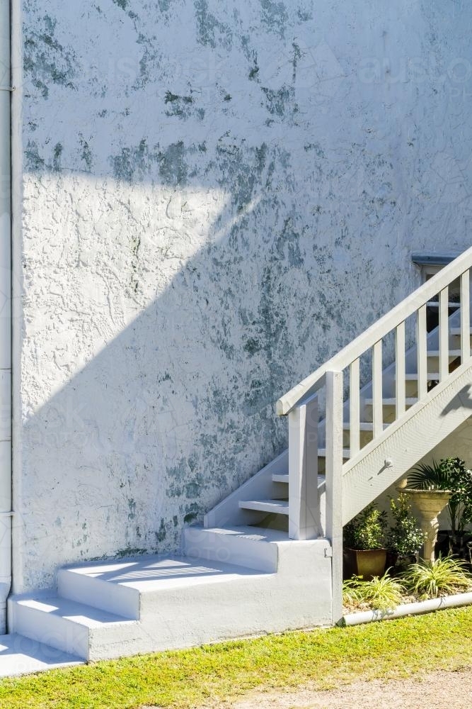 Stairs leading up the side of a cement wall. - Australian Stock Image