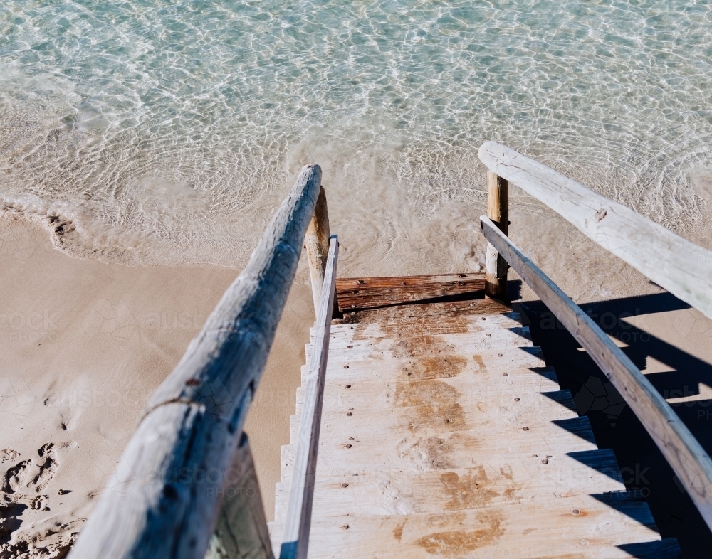 Stairs to the crystal clear ocean - Australian Stock Image