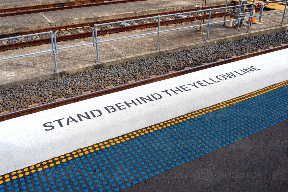 Stand behind the yellow line - Australian Stock Image