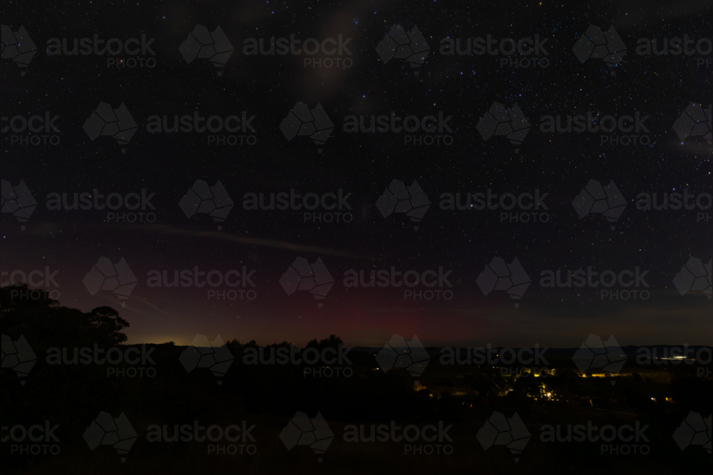 Starry night sky over rural New South Wales with faint Aurora Australis - Australian Stock Image