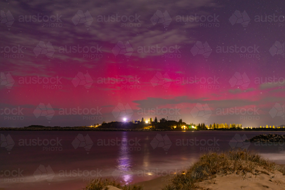 Starry night sky over Yamba NSW with vibrant pink and purple Aurora Australis - Australian Stock Image
