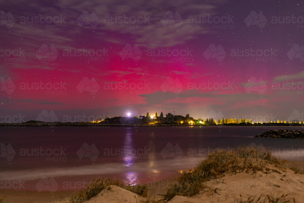 Starry night sky over Yamba NSW with vibrant pink and purple Aurora Australis - Australian Stock Image