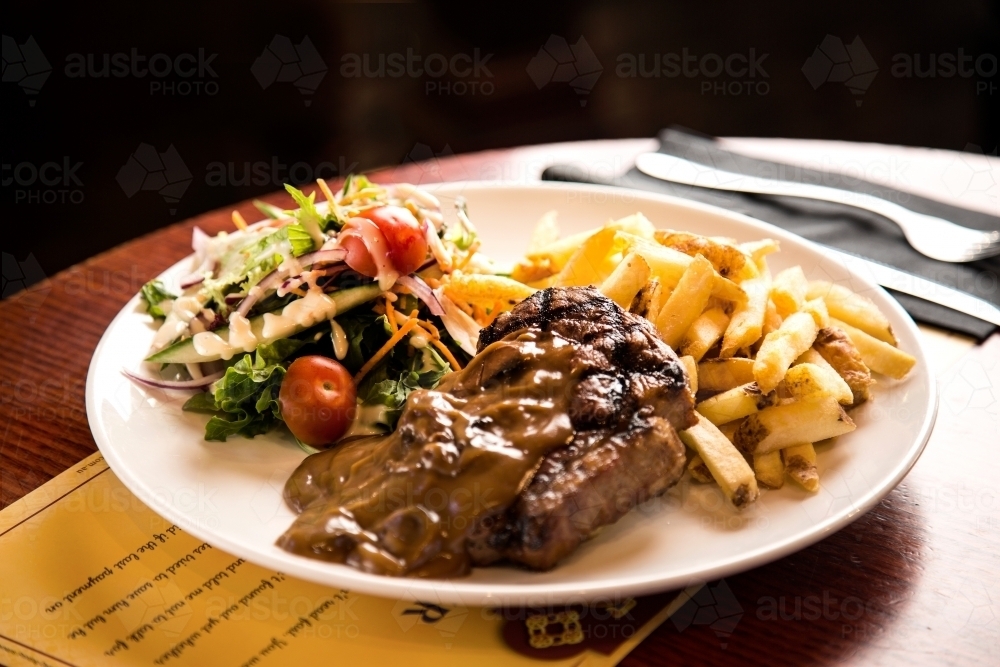 Steak and chips meal at pub - Australian Stock Image