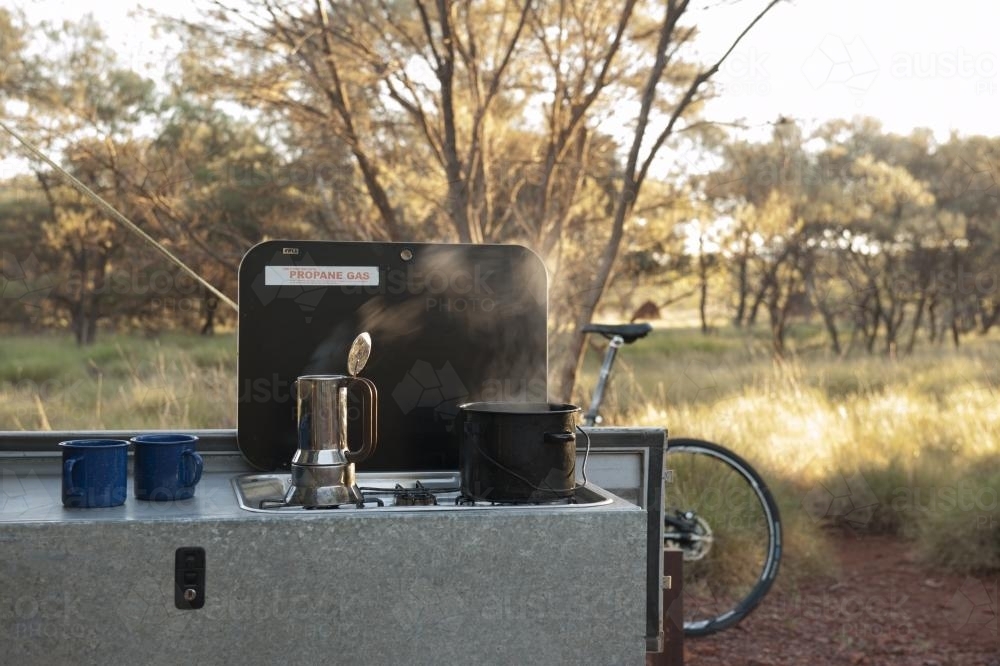 steaming coffee pot at bush campsite - Australian Stock Image