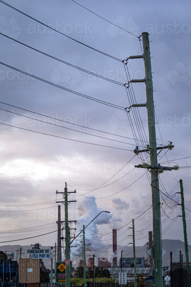 Steel Smelter behind power lines and poles - Australian Stock Image