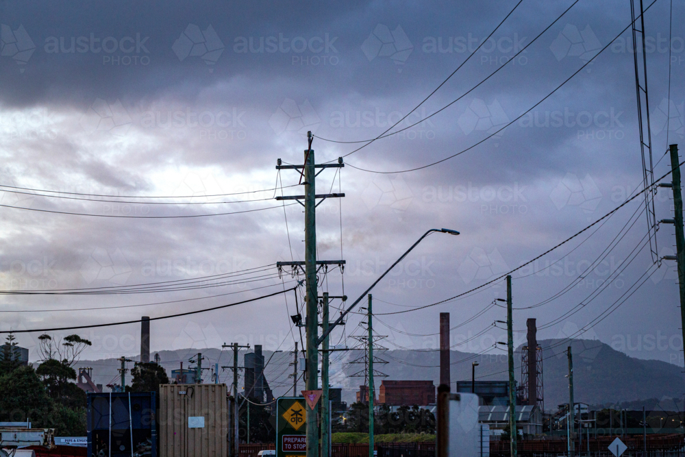 Steel Smelter behind power lines and poles - Australian Stock Image