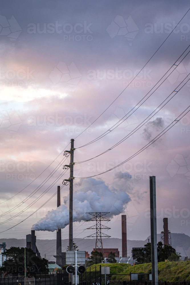Steel Smelter behind power lines and power pole - Australian Stock Image