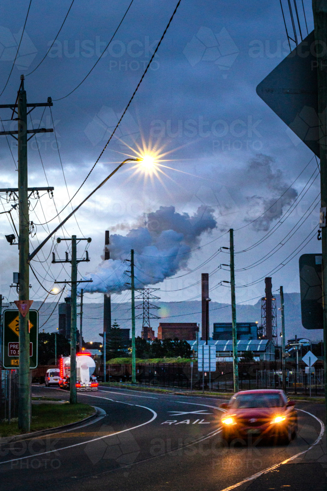 Steel Smelter factory behind power lines and road - Australian Stock Image