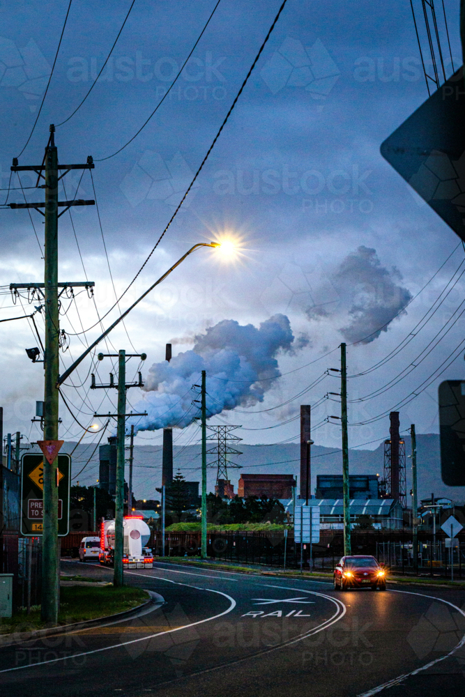 Steel Smelter factory with power lines and road in foreground - Australian Stock Image