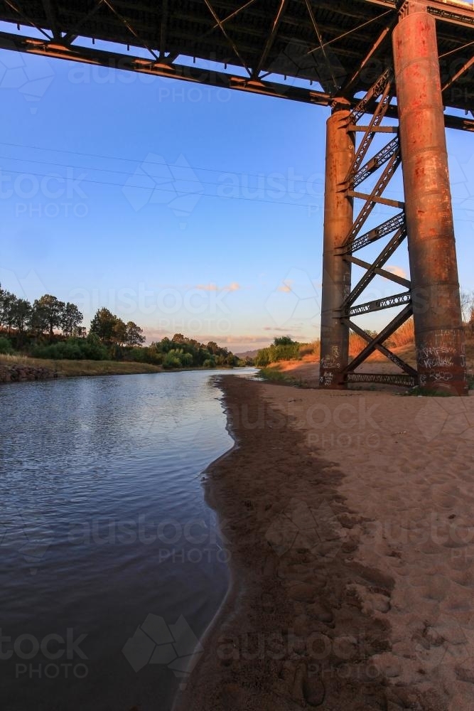 Steel support pylons and bridge over country river - Australian Stock Image
