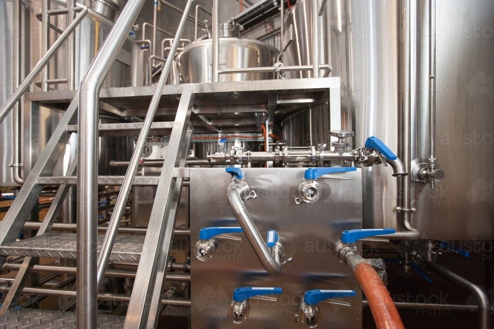 Steps and valves at a microbrewery - Australian Stock Image