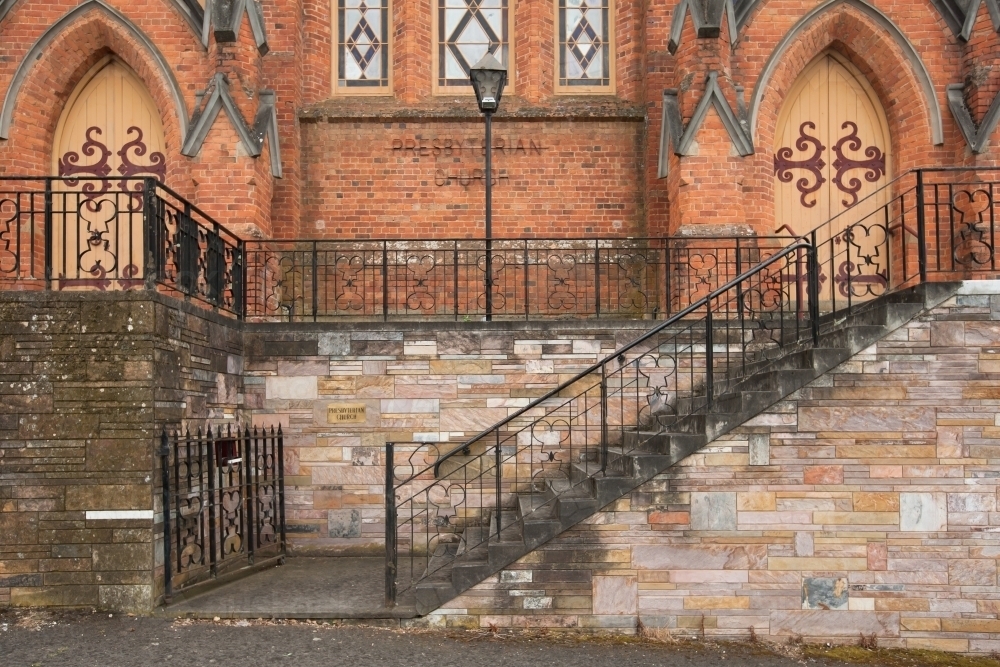 steps and wrought iron railing at entrance of a regional church - Australian Stock Image