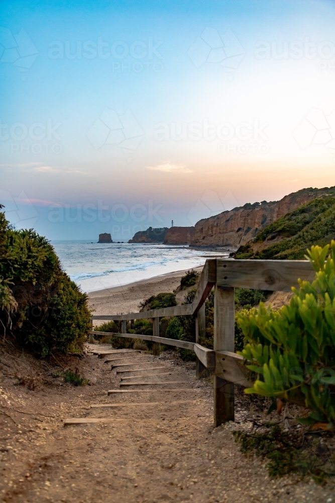 steps leading down to beach at bottom of cliff - Australian Stock Image
