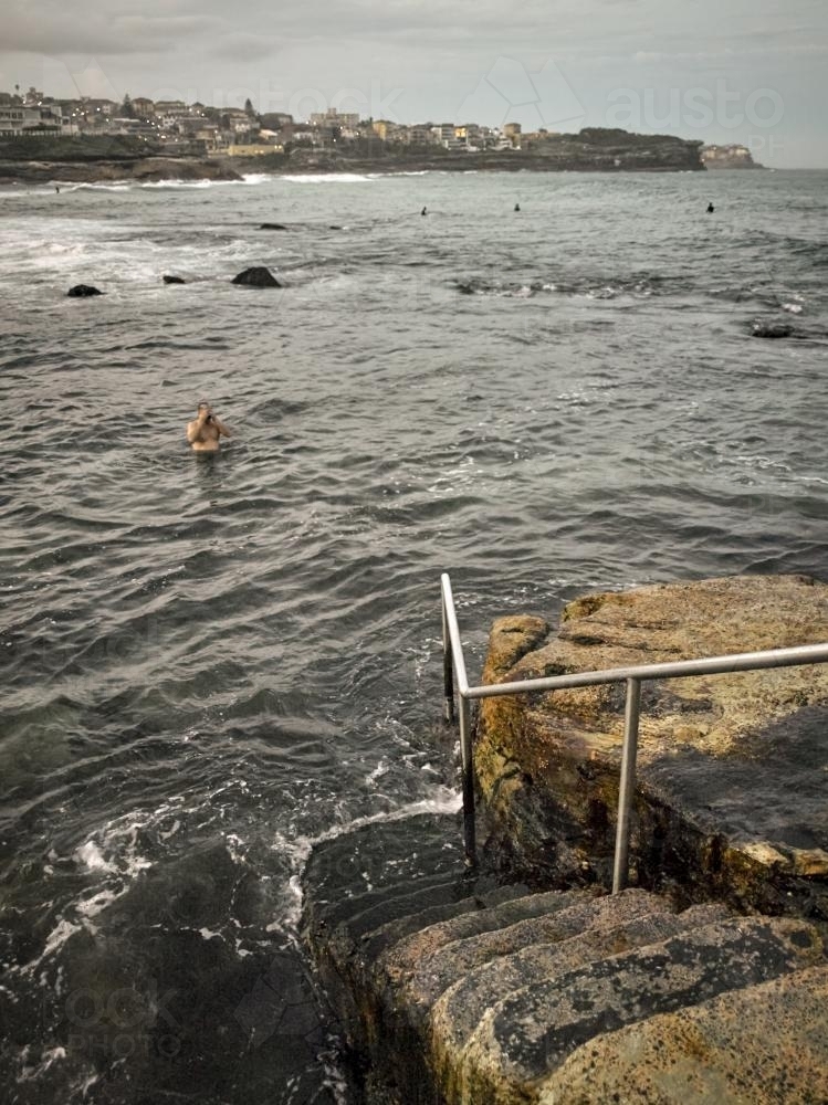 Steps leading down to sea and swimmer near Bronte Ocean pool - Australian Stock Image