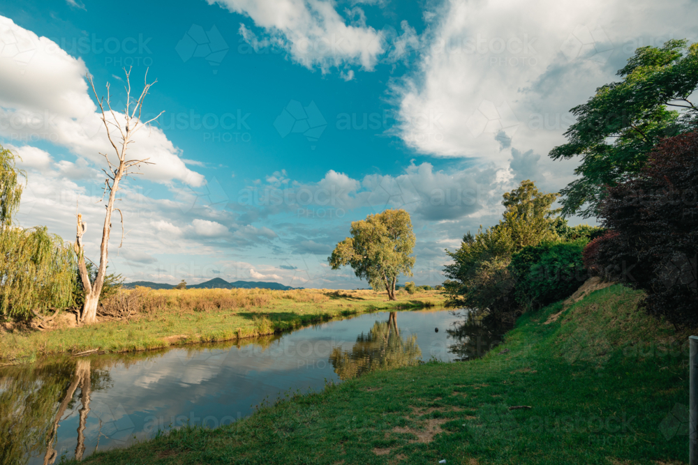 Still creek running through tranquil rural Australian setting - Australian Stock Image