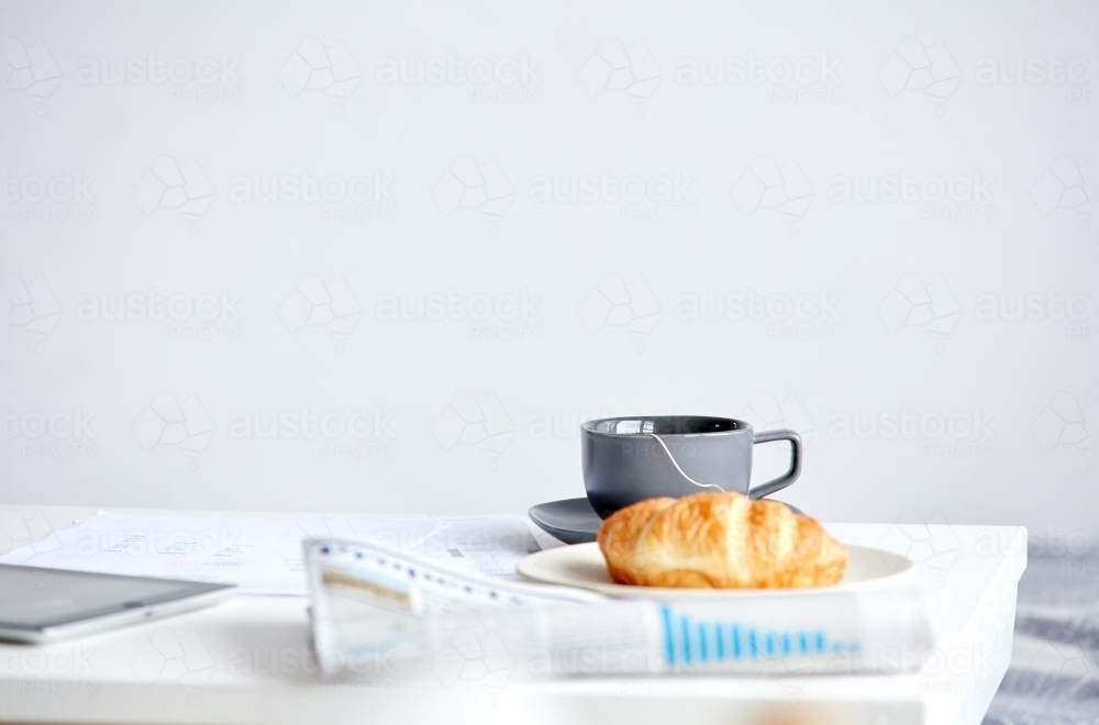 Still life of newspaper and breakfast on table - Australian Stock Image