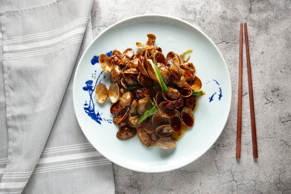Image of Stir fried clams with xo sauce dish on table Austockphoto