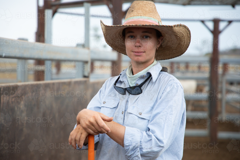 Stock woman standing in cattle yards - Australian Stock Image