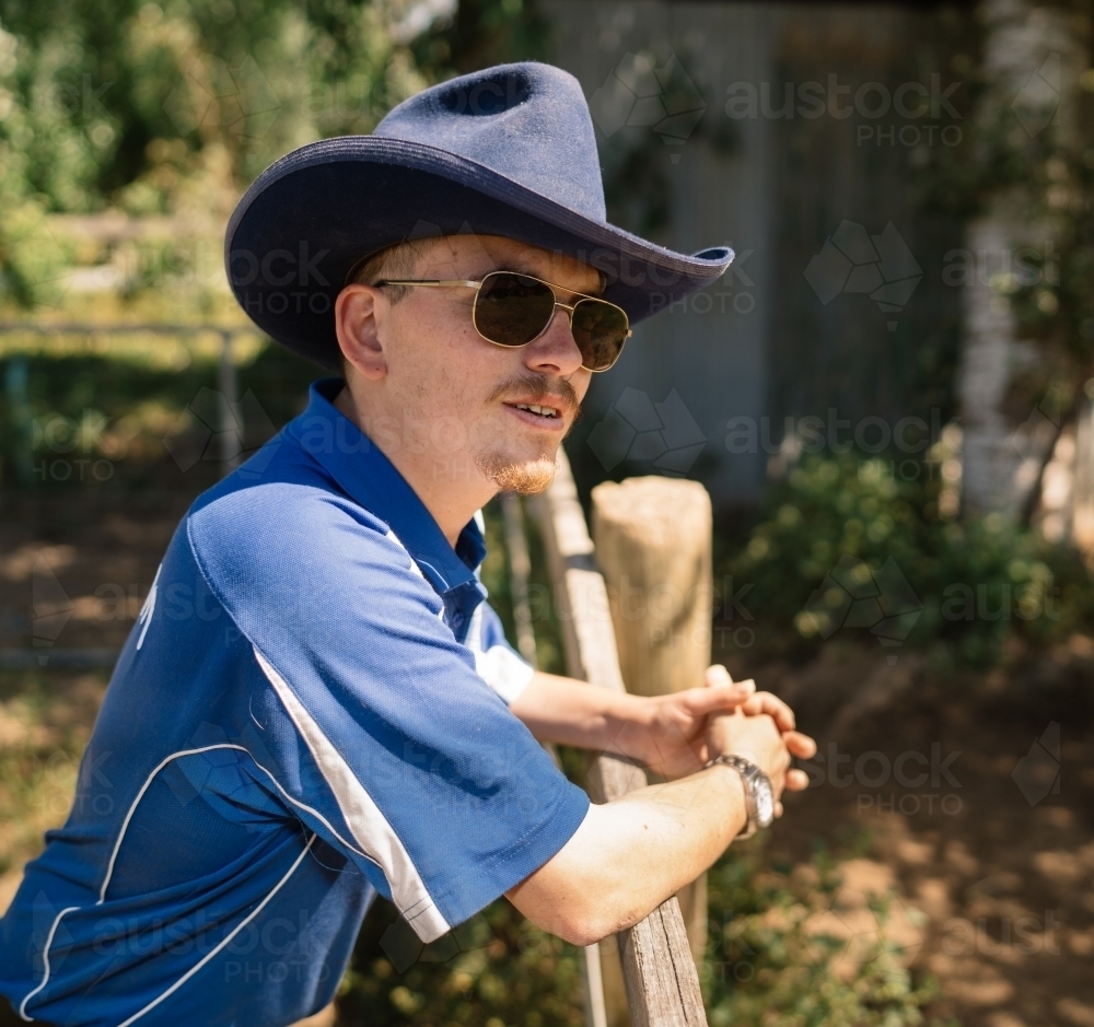Stockman Leaning on a Fence - Australian Stock Image