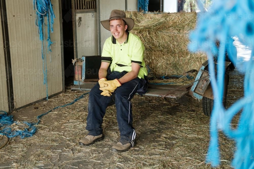 Stockman on a Trailer in a Farm Shed - Australian Stock Image