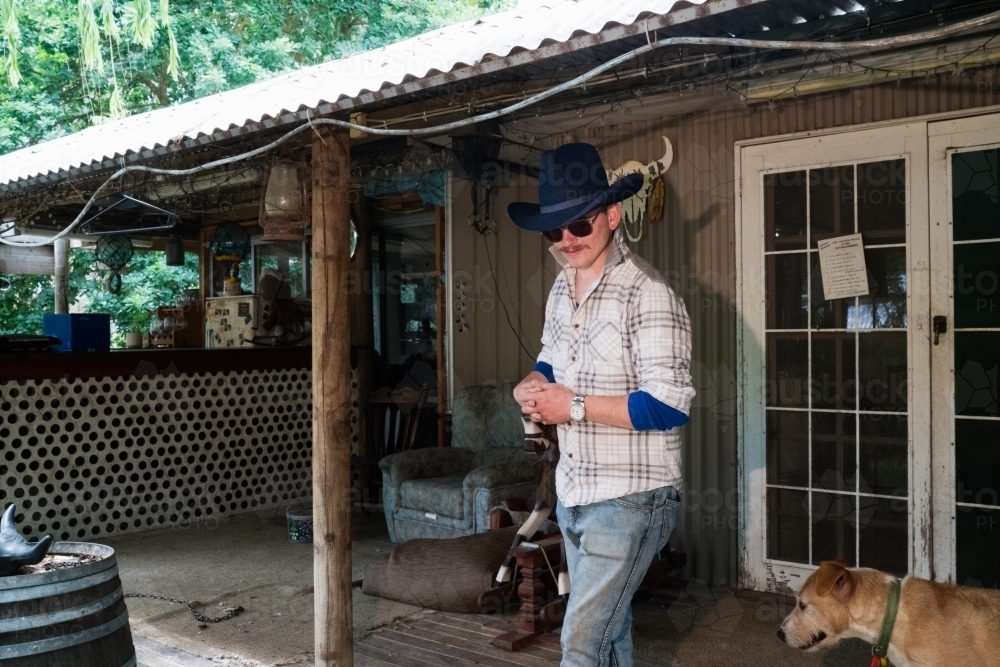 Stockman on Verandah of Farmhouse - Australian Stock Image