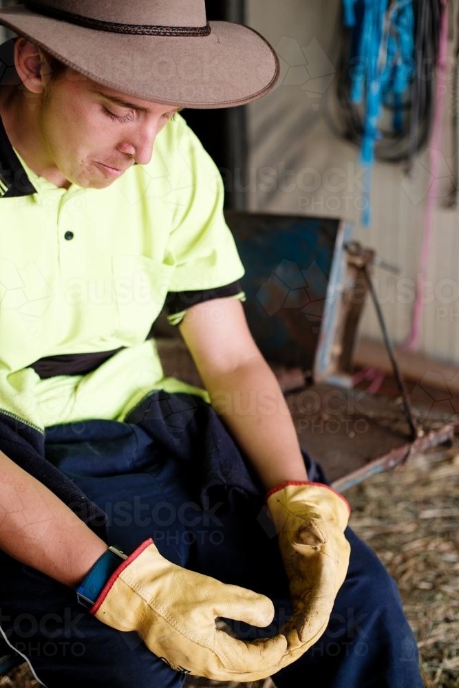 Stockman Seated in a Farm Shed - Australian Stock Image