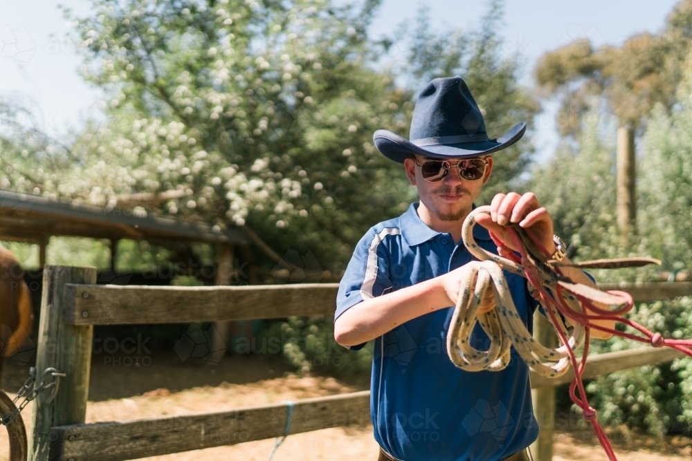 Stockman with Hat Winding a Rope - Australian Stock Image