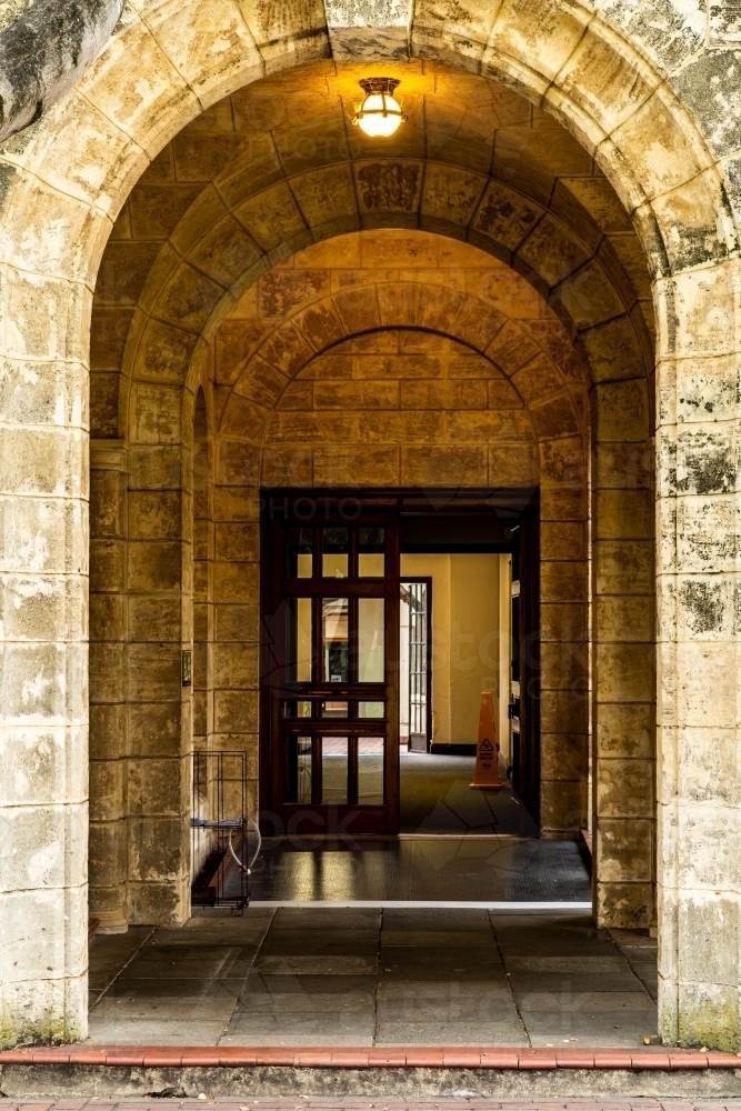 Stone archway entry in old stone building. - Australian Stock Image
