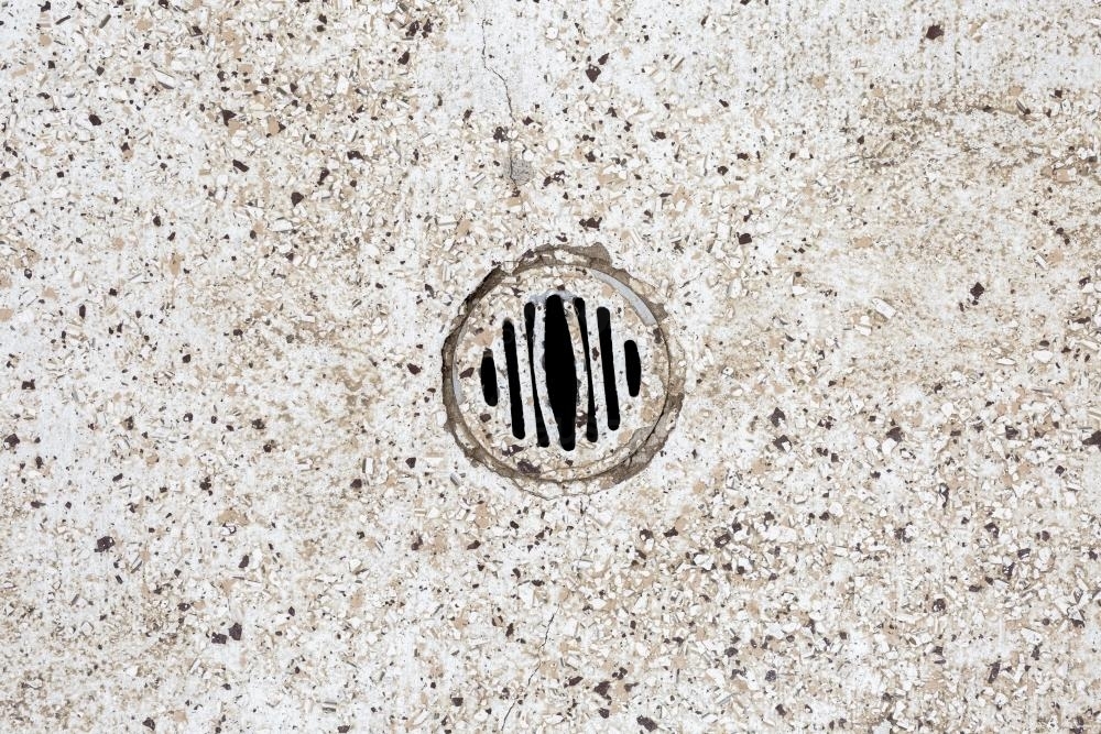 Stone floor with water drain in public toilets - Australian Stock Image