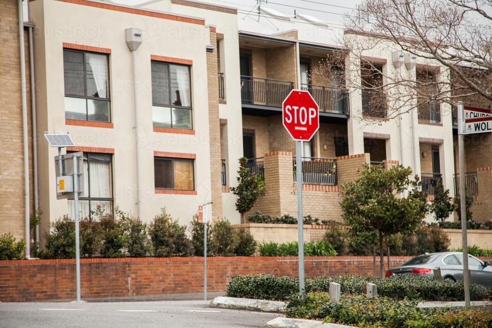 Stop sign at intersection near complex houses in Newcastle - Australian Stock Image