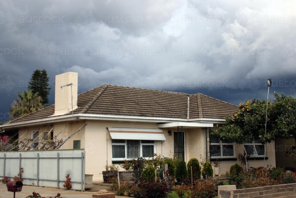 Storm brewing above suburban house - Australian Stock Image