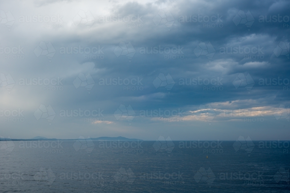 Storm brewing over ocean and headland - Australian Stock Image