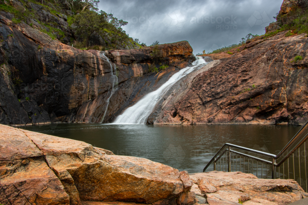 Storm clouds gather over Serpentine Falls - Australian Stock Image