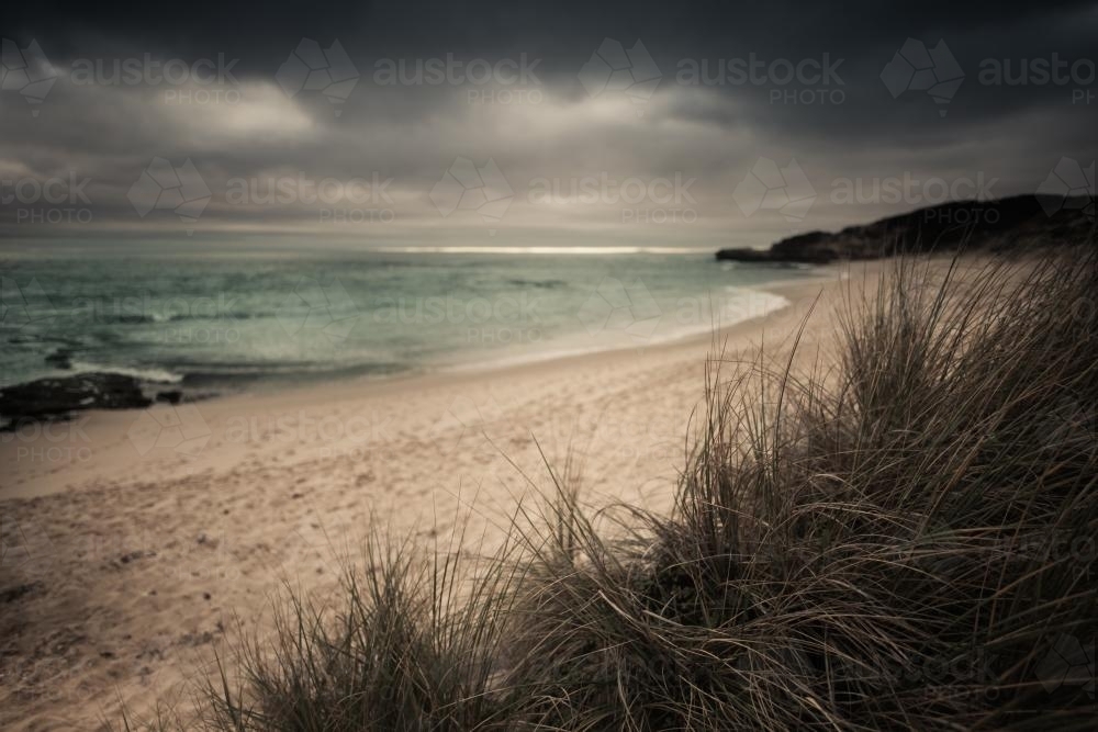Storm clouds gathering over a pristine beach - Australian Stock Image