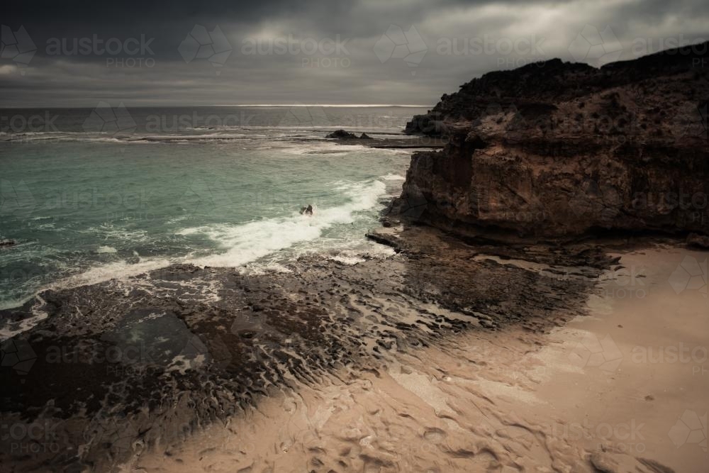 Storm clouds gathering over a pristine beach - Australian Stock Image
