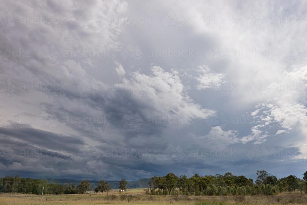 Storm Clouds over paddocks in the Hunter Valley - Australian Stock Image