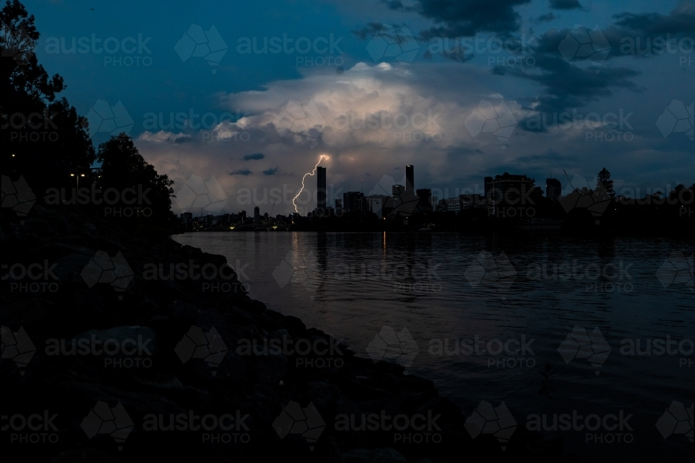 Storm clouds with lightning striking above Brisbane City. - Australian Stock Image