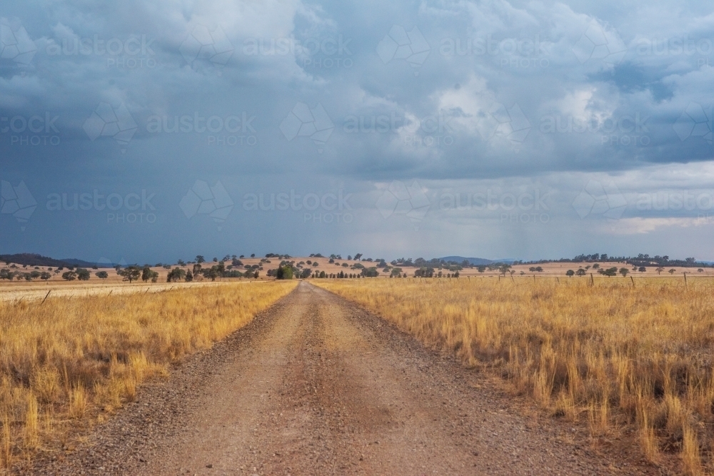 Storm coming along country dirt road. - Australian Stock Image