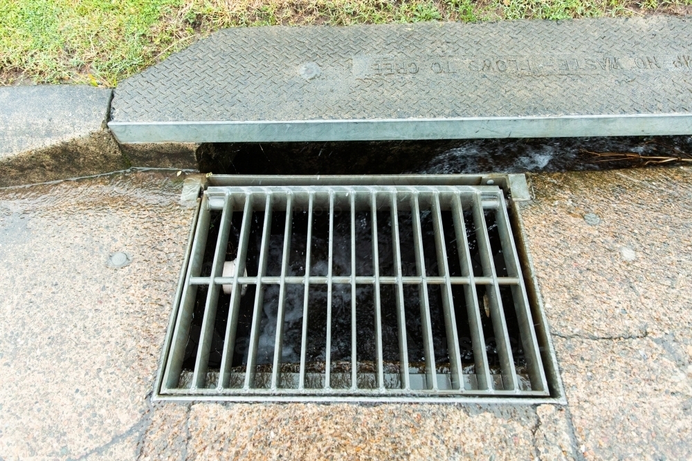 Image of stormwater drain and grate - Austockphoto
