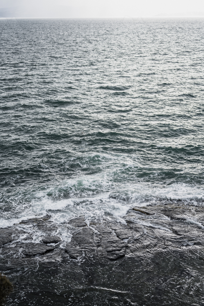 stormy sea and rock face - Australian Stock Image