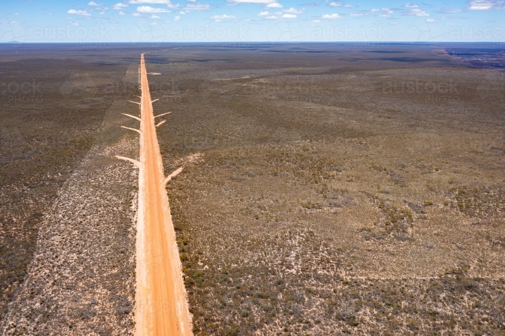 straight gravel road leading to horizon through wilderness area - Australian Stock Image