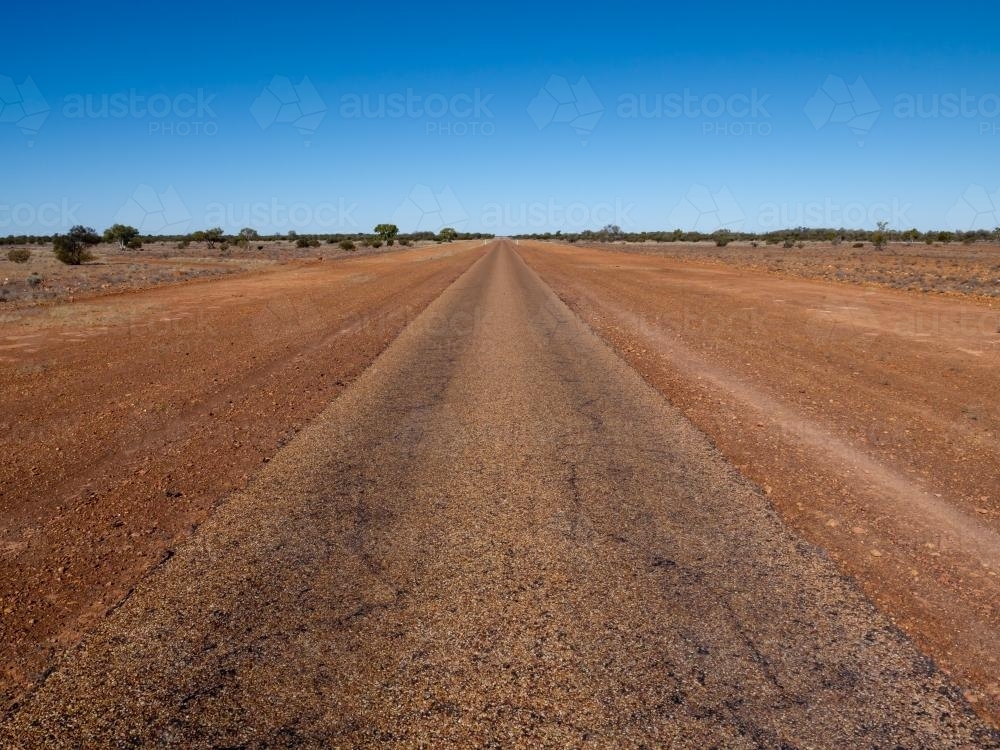 Straight single laned sealed road disappearing in the distance - Australian Stock Image