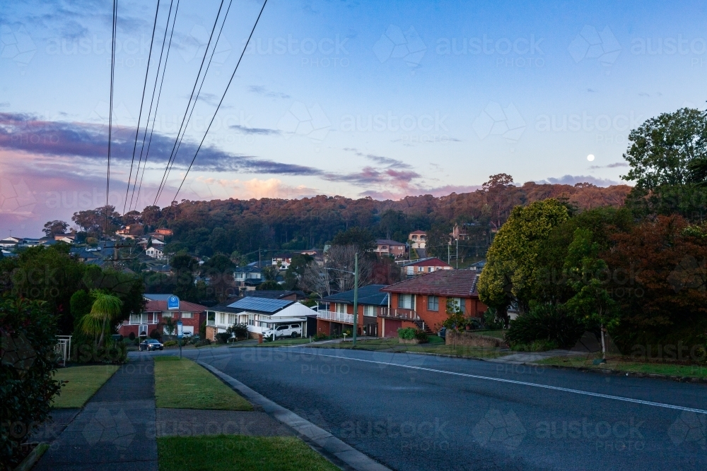 street at dusk with homes along roadside in suburb of Wallsend in Newcastle - Australian Stock Image