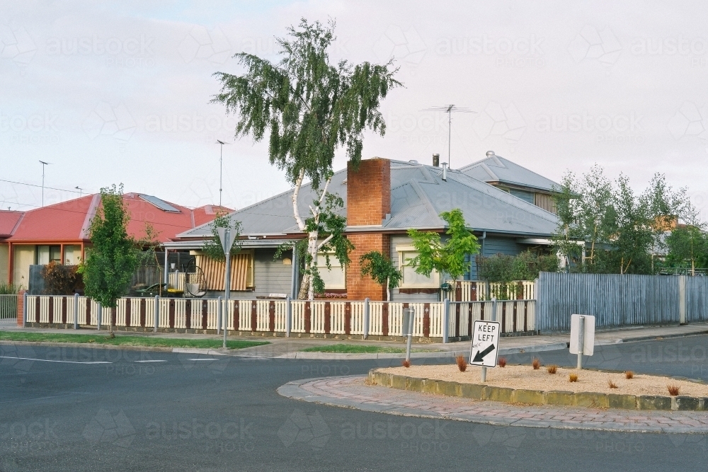 Street corner view of suburban house with picket fence - Australian Stock Image