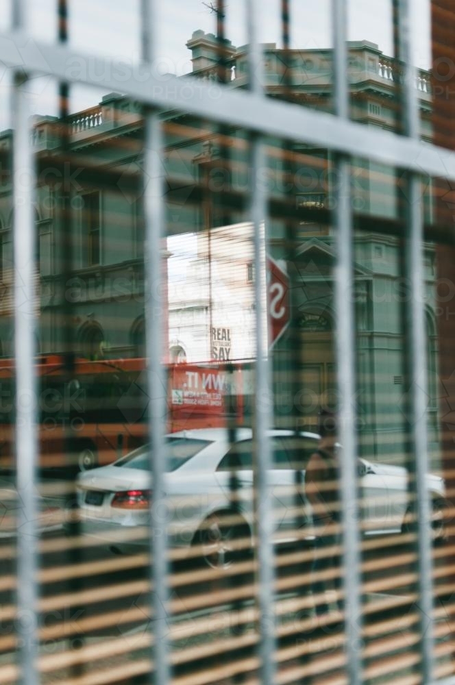 Street Reflection in a window with bars - Australian Stock Image