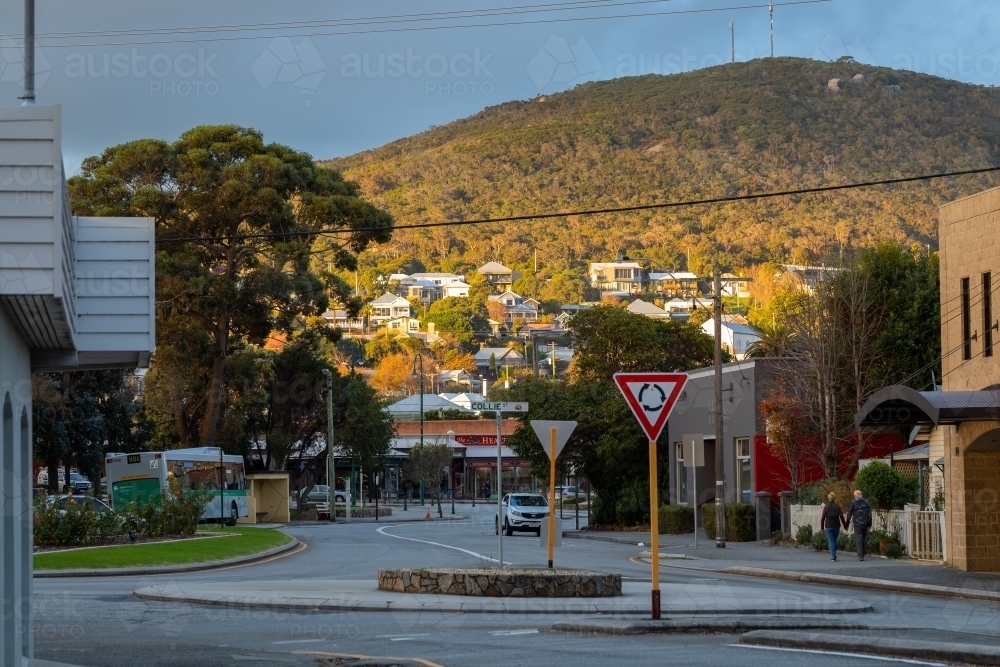 street view in Albany, with houses on hillside bathed in sunshine. - Australian Stock Image